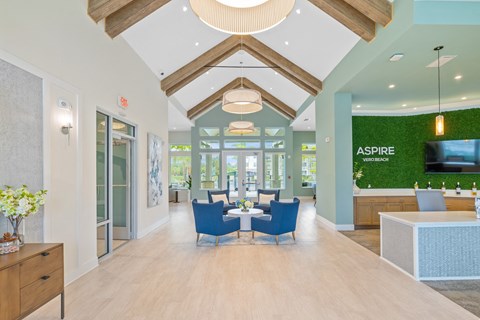 a dining room with blue chairs and a table in the middle